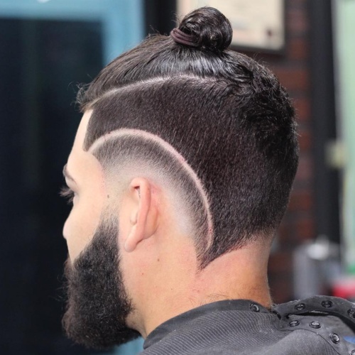 high razor cut low fade haircut with man bun hairstyle